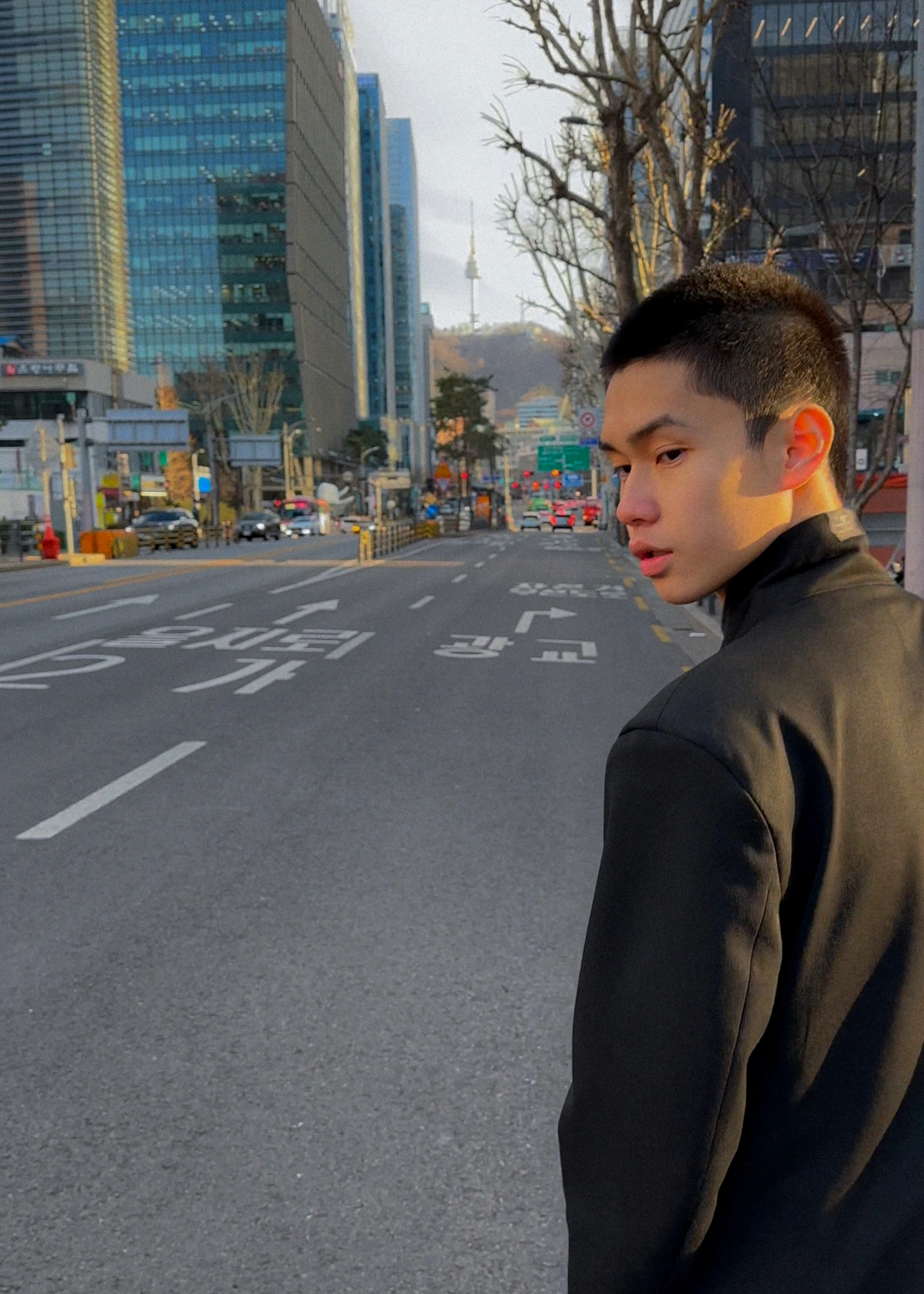 A street portrait against glass and concrete