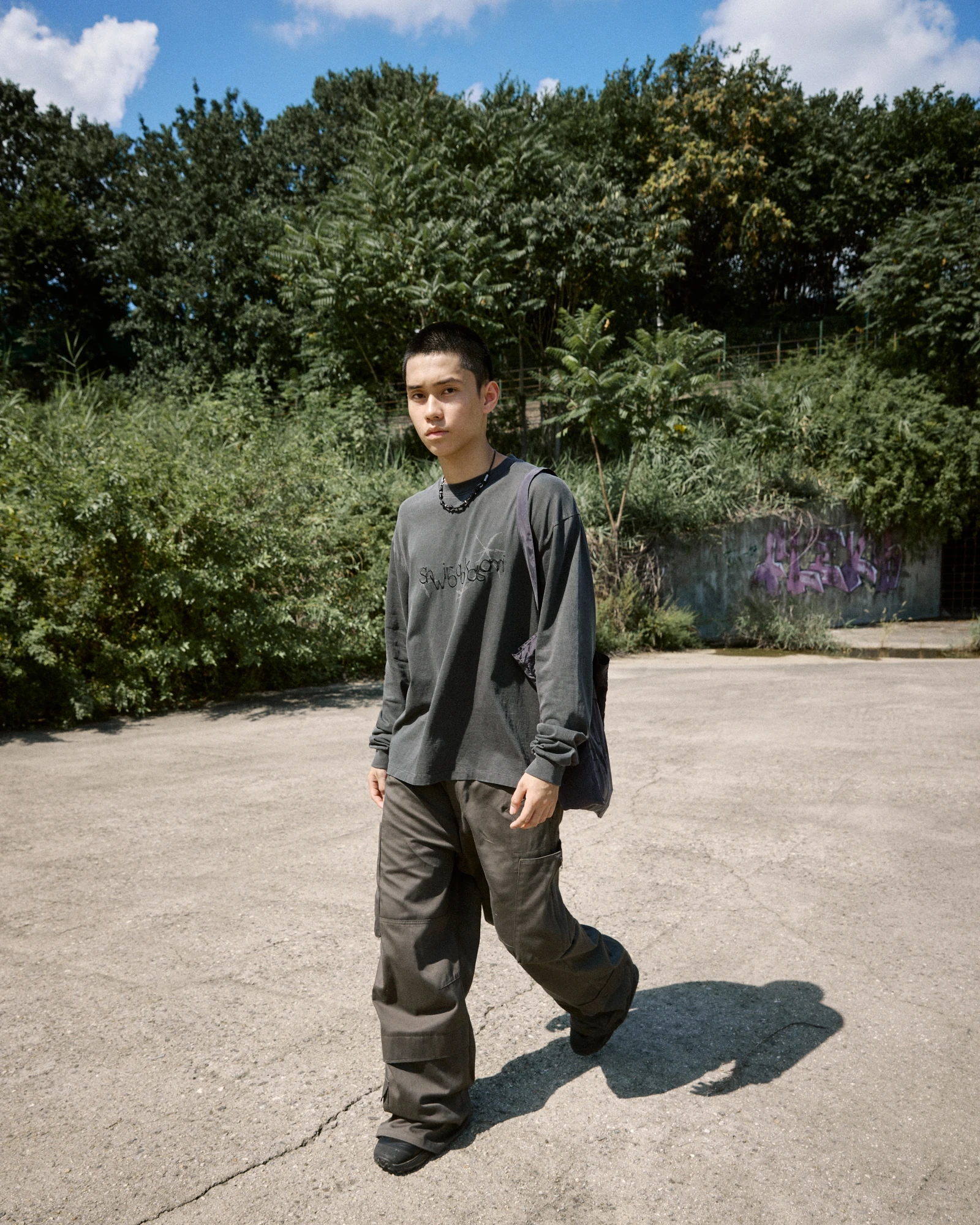 A full-length portrait on a sunlit path