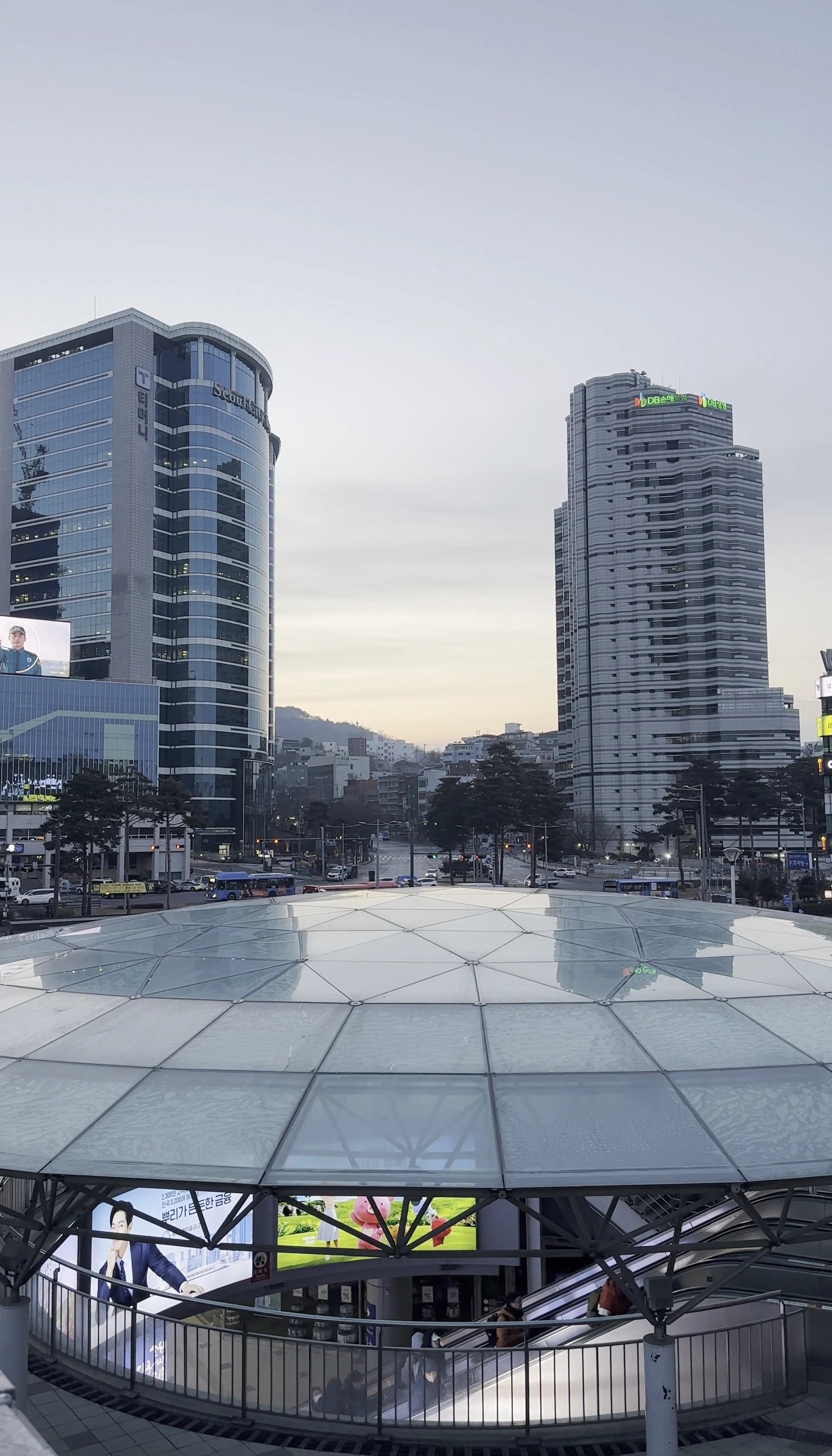 A cityscape seen through a glass pavilion
