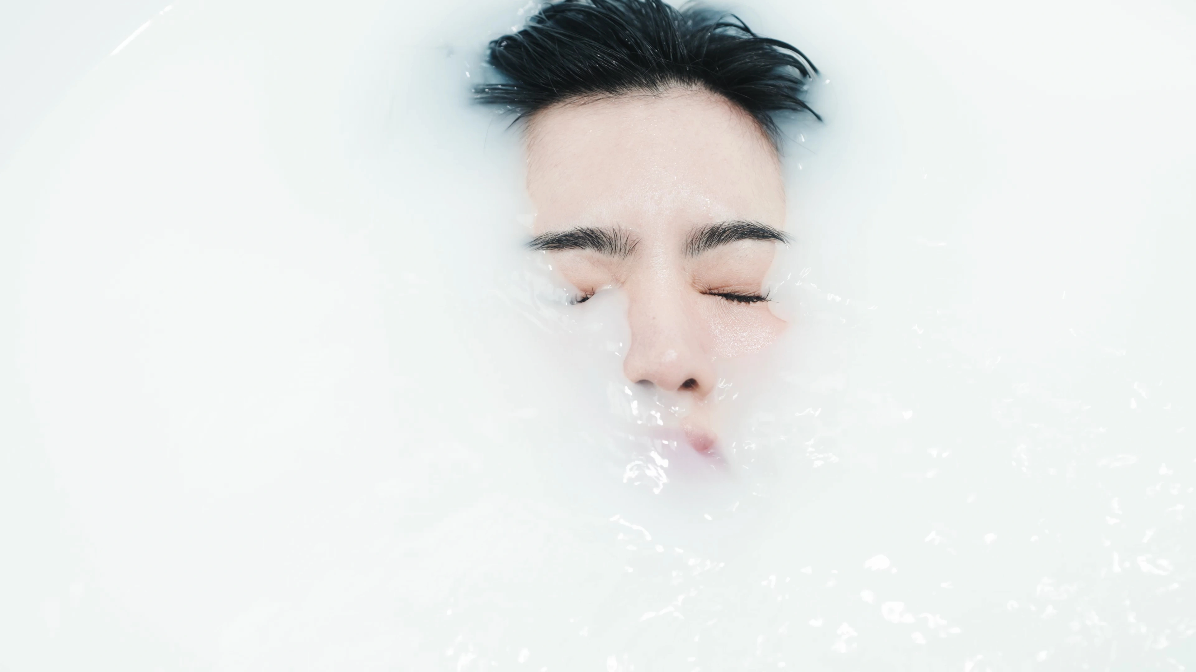 A face surrounded by translucent bubbles