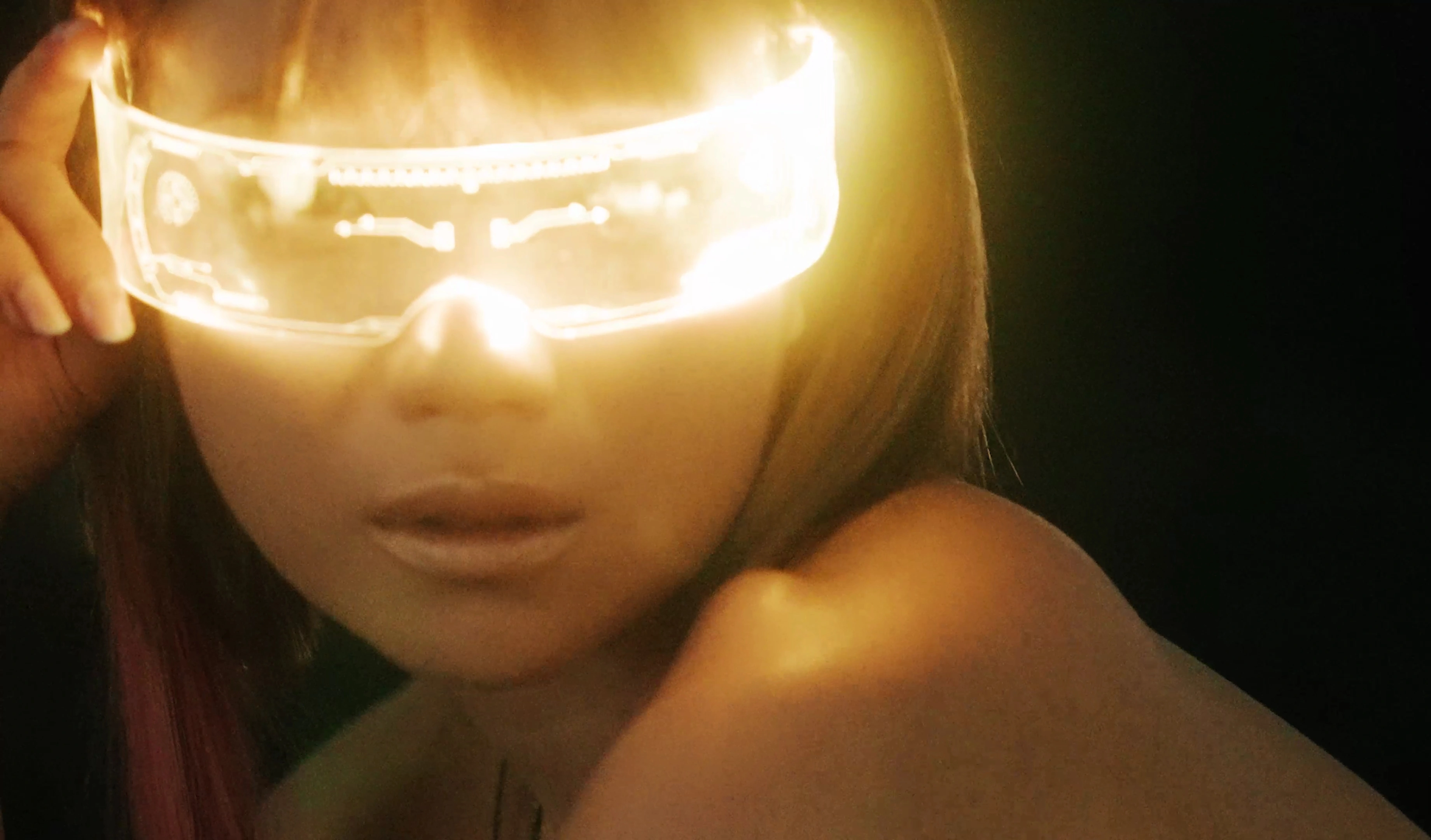 A portrait behind a luminous gold visor