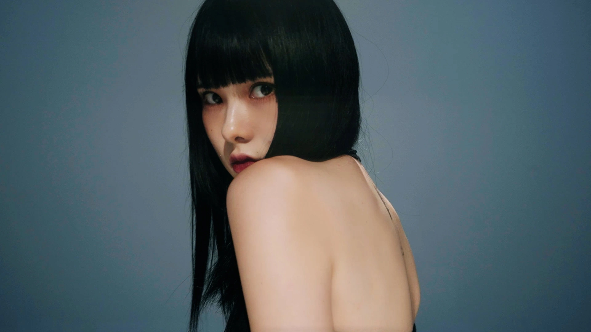 A short-haired portrait against deep blue